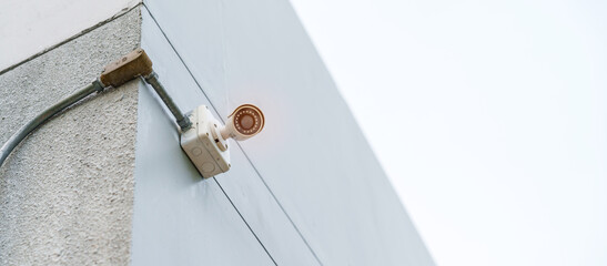 Modern CCTV camera against city and sky background. surveillance, video record and monitoring concept