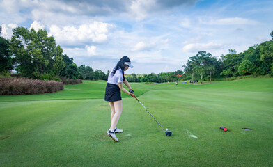 Professional woman golfer teeing golf in golf tournament competition at golf course for winner.	