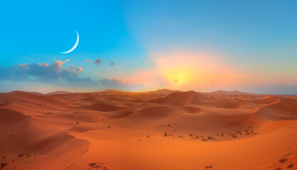 Beautiful sand dunes in the Sahara desert with crescent moon at sunrise - Sahara, Morocco