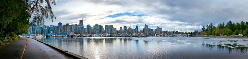 Fototapeta na wymiar Panoramic view of Vancouver downtown from Stanley Park. Skyscrapers are reflected in the waters of Vancouver Harbor. Canada