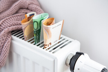 Radiator, warm cloth and euro money banknotes. Saving home heating, expensive payment for heating.