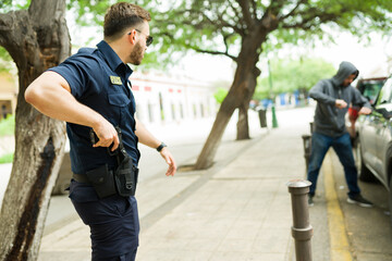 Cop getting ready to use his gun arresting a robber