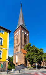 XV century St. John the Baptist gothic church in historic old town quarter of Stargard in Poland - obrazy, fototapety, plakaty