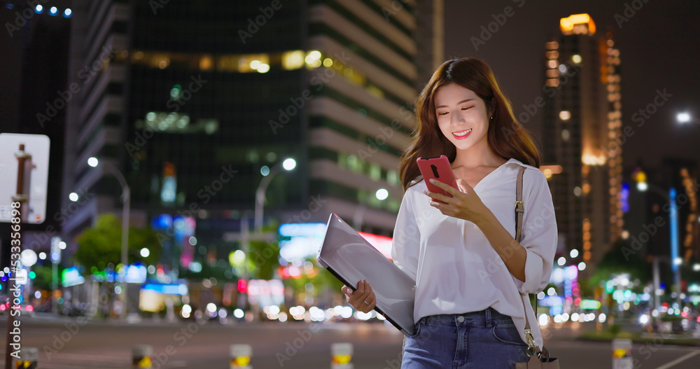 Wall mural businesswoman is walking in city