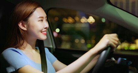 woman is driving at night