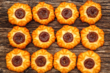 Fresh homemade biscuits in stock. Sweet cookies on a wooden table. Dessert sweet biscuits for tea and coffee. Concept of yummy, cookies, desserts.