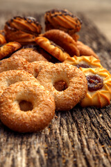 Fresh homemade biscuits in stock. Sweet cookies on a wooden table. Dessert sweet biscuits for tea and coffee. Concept of yummy, cookies, desserts.