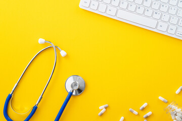 Blue stethoscope with computer keyboard and capsule pill, medical design concept. - obrazy, fototapety, plakaty