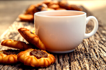 Homemade sweet cookies with tea. Delicious sweet cookies with tea on the table. Dessert cookies with tea in a cafe. The concept of desserts, sweets, coffee shop.