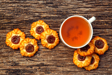 Homemade sweet cookies with tea. Delicious sweet cookies with tea on the table. Dessert cookies with tea in a cafe. The concept of desserts, sweets, coffee shop.