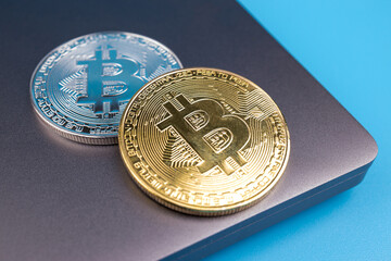 bitcoin coins lie on a laptop
