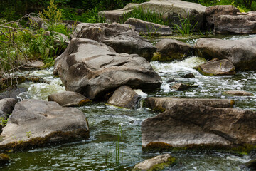 beautiful ripples on river flow over stones in summer