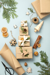 Natural color Christmas gift boxes on blue background, eco friendly trendy zero waste packaging...