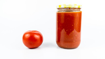 Fototapeta na wymiar Tomato sauce in a jar. Homemade tomato sauce making process concept idea on white background.