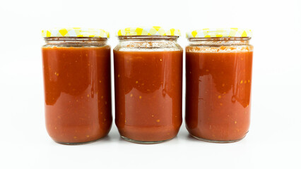 Tomato sauce in a jar. Homemade tomato sauce making process concept idea on white background.