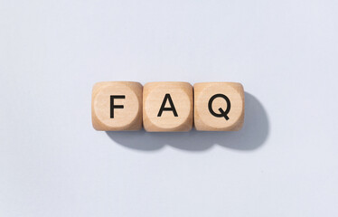FAQ or Frequently Asked Questions concept. Text on Wooden cube blocks isolated on gray background