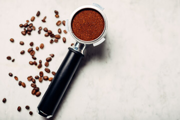 Portafilter for coffee machine with ground coffee and coffee beans
