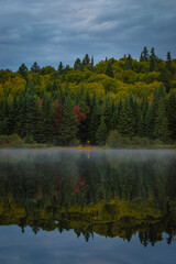 Wild photography alone on a lake in Canada, perfect reflection, nature picture