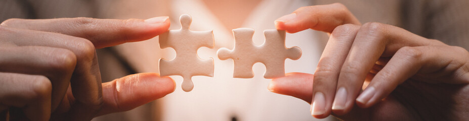Banner background of business hands connecting jigsaw puzzle, success and goal achievement, the last jigsaw is the link of all the pieces. strategic planning or a solution for the management. - obrazy, fototapety, plakaty