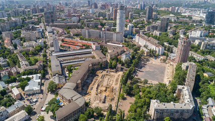 Fototapeta na wymiar Aerial view beautiful Kyiv cityscape on a sunny summer day. Drone shot Kiev building, former factory Arsenal. Capital of Ukraine. Construction