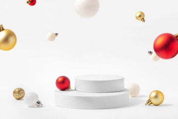 Cosmetic background for Christmas and winter holiday. White podium and christmas balls on white...