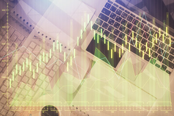Financial market graph and top view computer on the desktop background. Multi exposure. Investment concept.