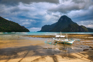 Traditional Boat in the Bay of El Nido, with Cadlao Island, Palawan, Philippines