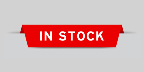 Red color inserted label with word in stock on gray background