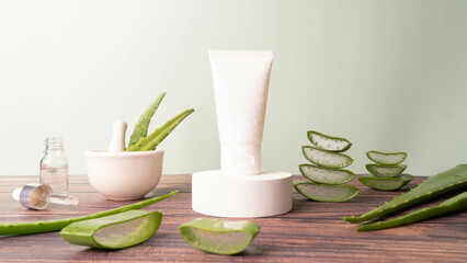 Natural moisturizer skincare product with fresh aloe vera. Blank white squeeze bottle plastic tube on circle podium. Packaging of cream, body lotion, gel or facial foam. Cosmetics branding mock up.