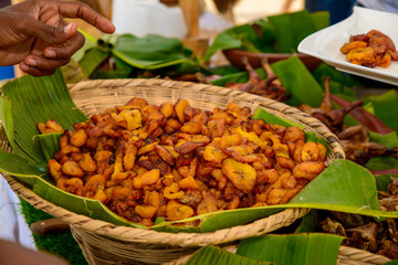 african food in banana leaves, chicken, fries