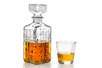 Whiskey in decorated crystal glass bottle, whisky or bourbon in vintage bottle with glass isolated on white, clipping path