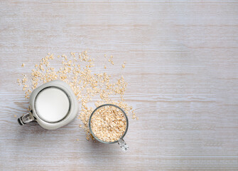 Fototapeta na wymiar Top view of fresh oat milk glass. Lactose free milk.