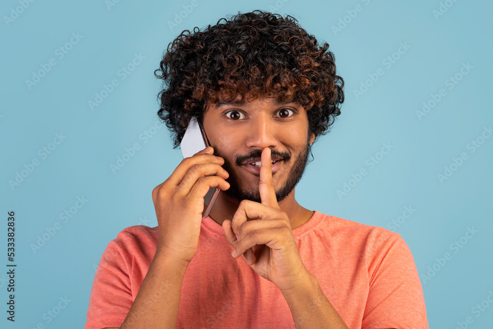 Canvas Prints Closeup of happy indian guy having phone conversation and gesturing