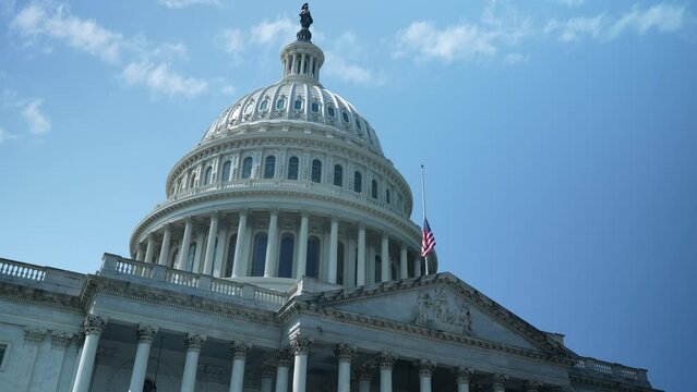 Push Into The US Capitol Dome With Flag At Half Mast, Seat Of Government In Washington, DC On A Beautiful Sunny Day With Clear Blue Sky.