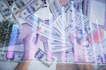 Multi exposure of financial graph drawing hologram and USA dollars bills and man hands. Analysis concept.
