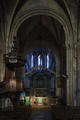 Interior of the Church of Notre-Dame with altar and colorful windows in the french town of Carentan, Normandy, France