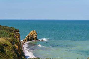 Cliffs at the northern french coast with the sea on a sunny summer day at Pointe du Hoc,...