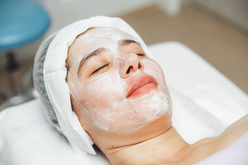 A cosmetologist does facial care and apply a face mask. cleansing a heavily soiled face. acne on the skin. skin rashes. mechanical face painting.