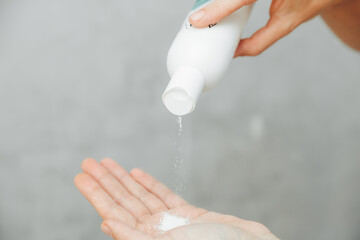 Cosmetologist pour the powder into the palm of your hand. skin care. powder for hair removal.