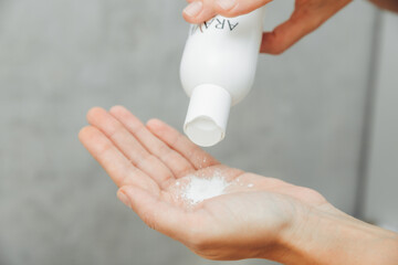 Cosmetologist pour the powder into the palm of your hand. skin care. powder for hair removal.