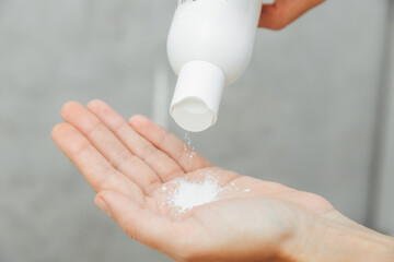 Cosmetologist pour the powder into the palm of your hand. skin care. powder for hair removal.