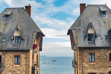 Two traditional houses in the village of Perros-Guirec, Brittany, France, with the typical sloping...