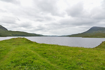 View of Loch Assynt at Inchnadamph with mountains beyond, Lairg, Highland, Scotland