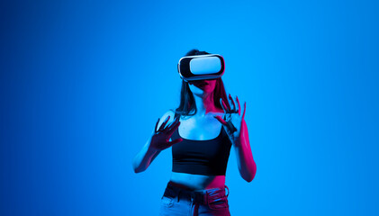 Impressed brunette woman using virtual reality headset, getting immersed experience, interacting...