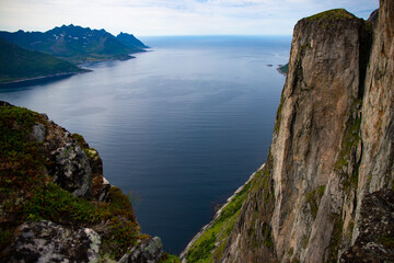 Fototapeta na wymiar Mighty mountains rising from the sea. The landscape of the stunning Norwegian island of Senja