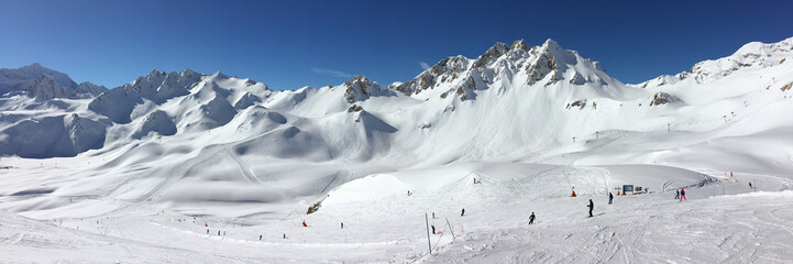 Panorama of snowy mountain peaks and ski slopes at Tignes, ski resort in the Alps, France