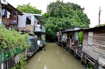 BANGKOK, THAILAND - September 29, 2022: The Old Wooden House on both sides of the sewage canal in Bangkok, Thailand.