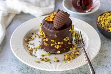 Pistachio cake. Bakery products. Chocolate and pistachio cake on a gray background. close up