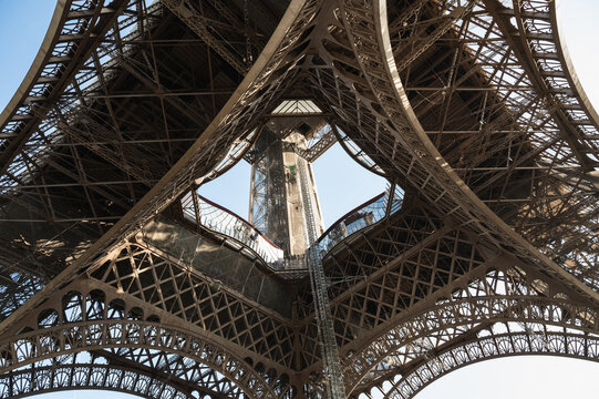 Inside the Eiffel tower. Close up of the iron structure. Distinctive symbol and famous tourist attraction of Paris, France, selective focus - Powered by Adobe