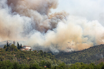 Fototapeta na wymiar Helicopter against wildfire during strong wind and drought near Miren Castle in Slovenia